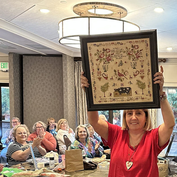 An antique sampler shown to the room